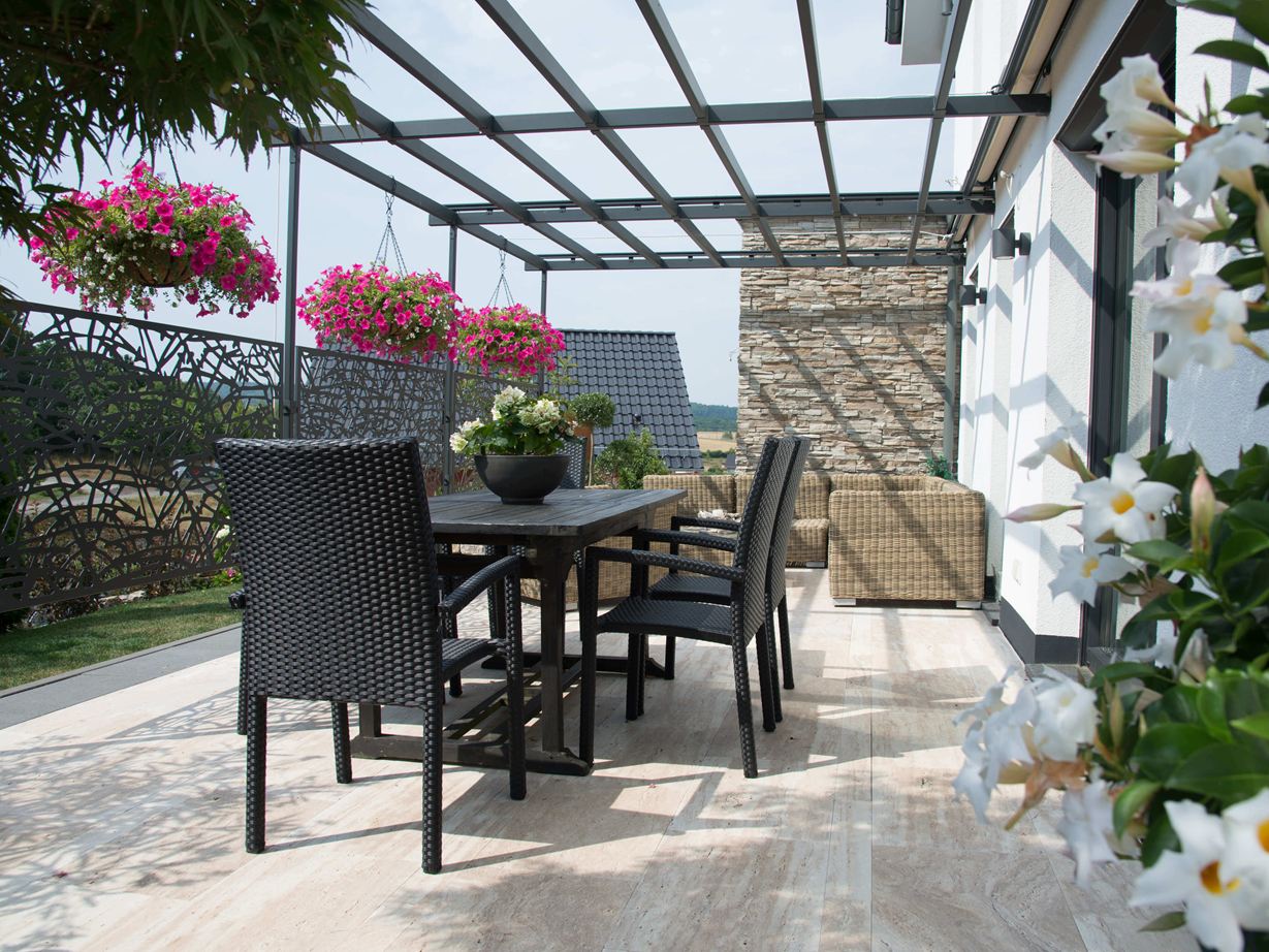 Ein natürliches Flair für eine moderne Terrasse! Terras met donker tuinmeubilair en houtachtige Natura travertin vloeren